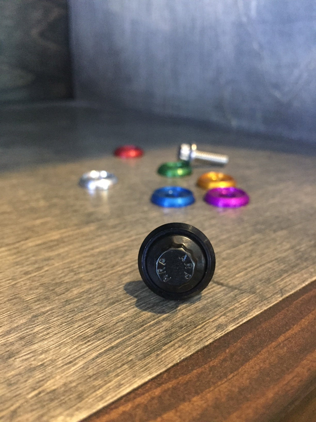 Black ARP 12-point Harley seat bolt with billet aluminum washer