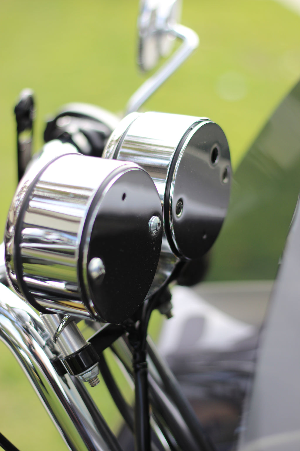 Dual gauge relocation kit mounted on Harley Dyna T-bars with speedometer and tachometer