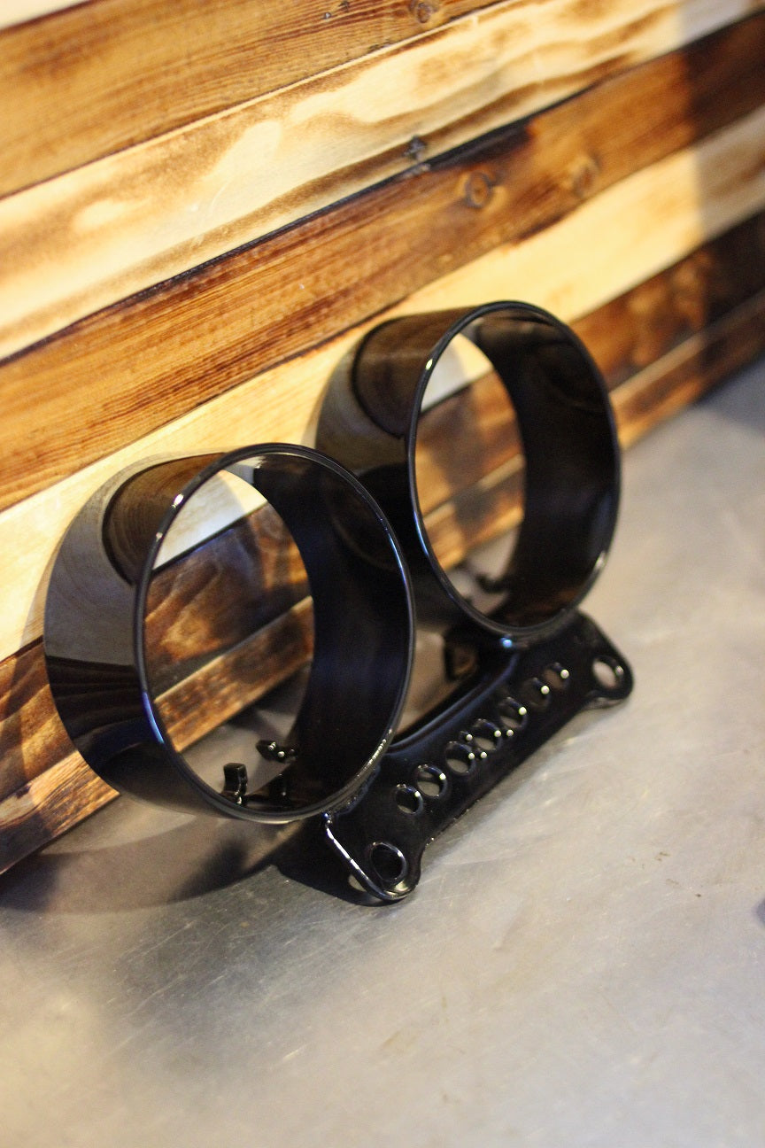 Dual gauge relocation kit mounted on Harley Dyna T-bars with speedometer and tachometer