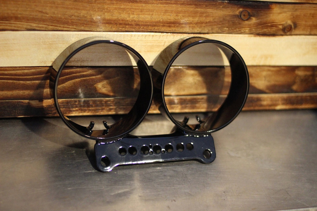 Dual gauge relocation kit mounted on Harley Dyna T-bars with speedometer and tachometer