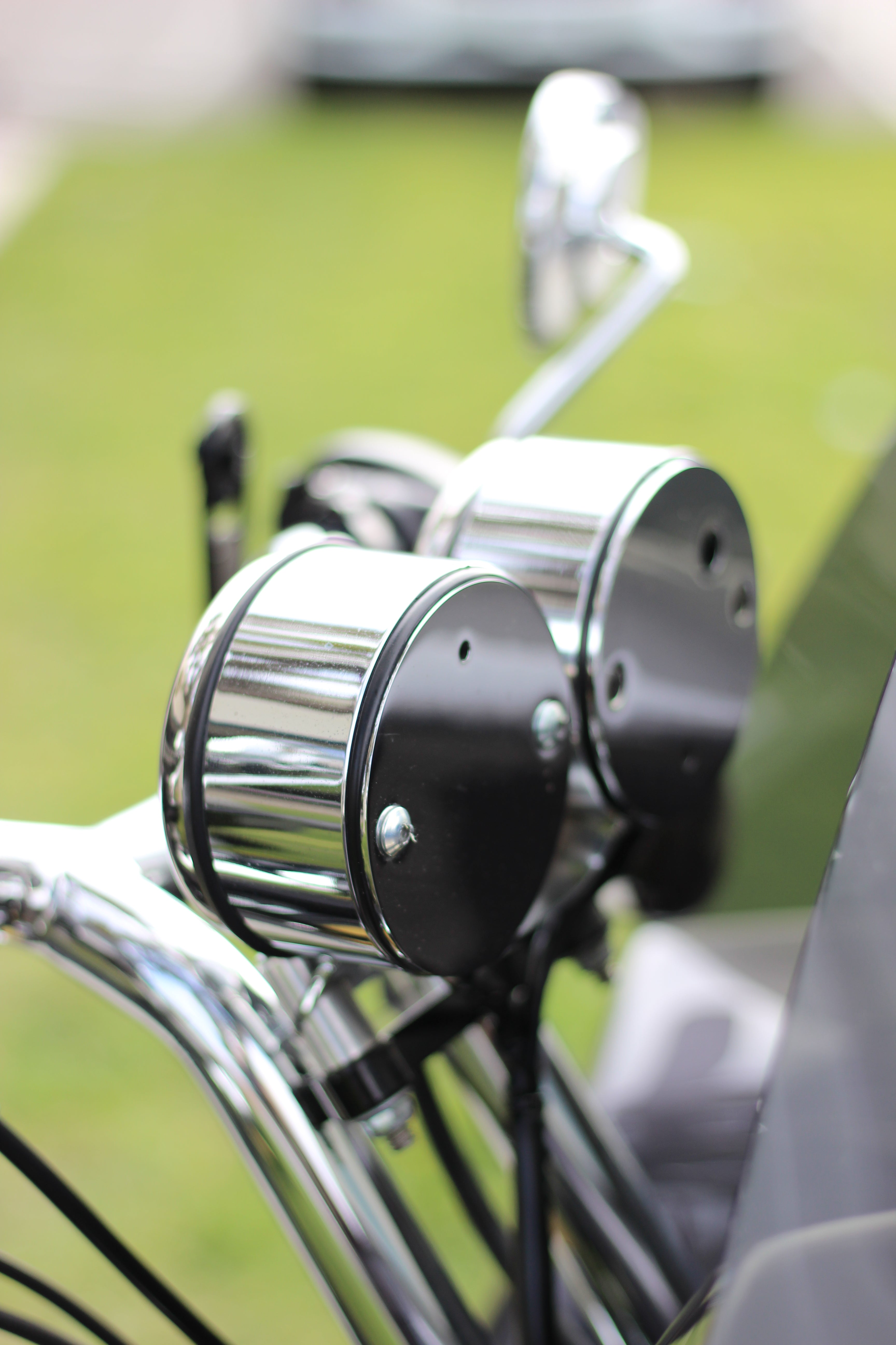 Dual gauge relocation kit mounted on Harley Dyna T-bars with speedometer and tachometer