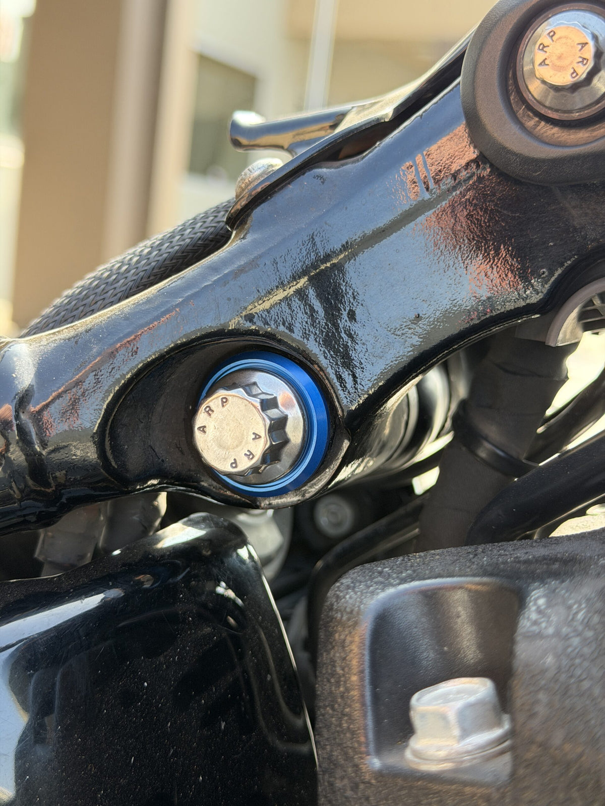 ARP upper shock mounting bolt installed on compatible Harley M8 Softail