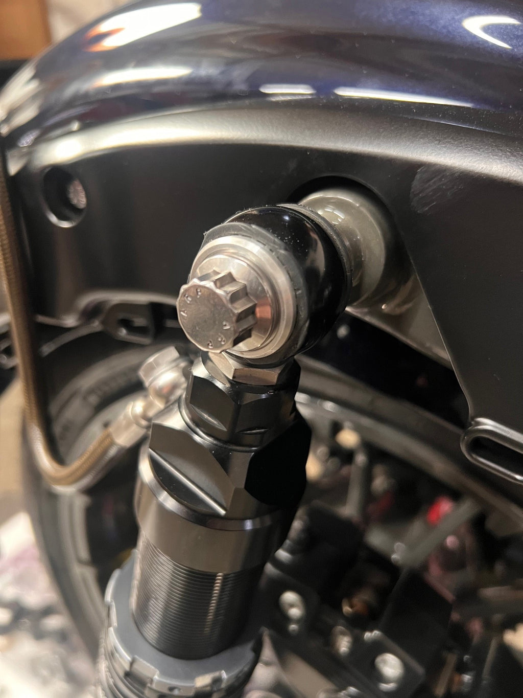 Billet beauty washer installed with compatible Harley rear shock bolt