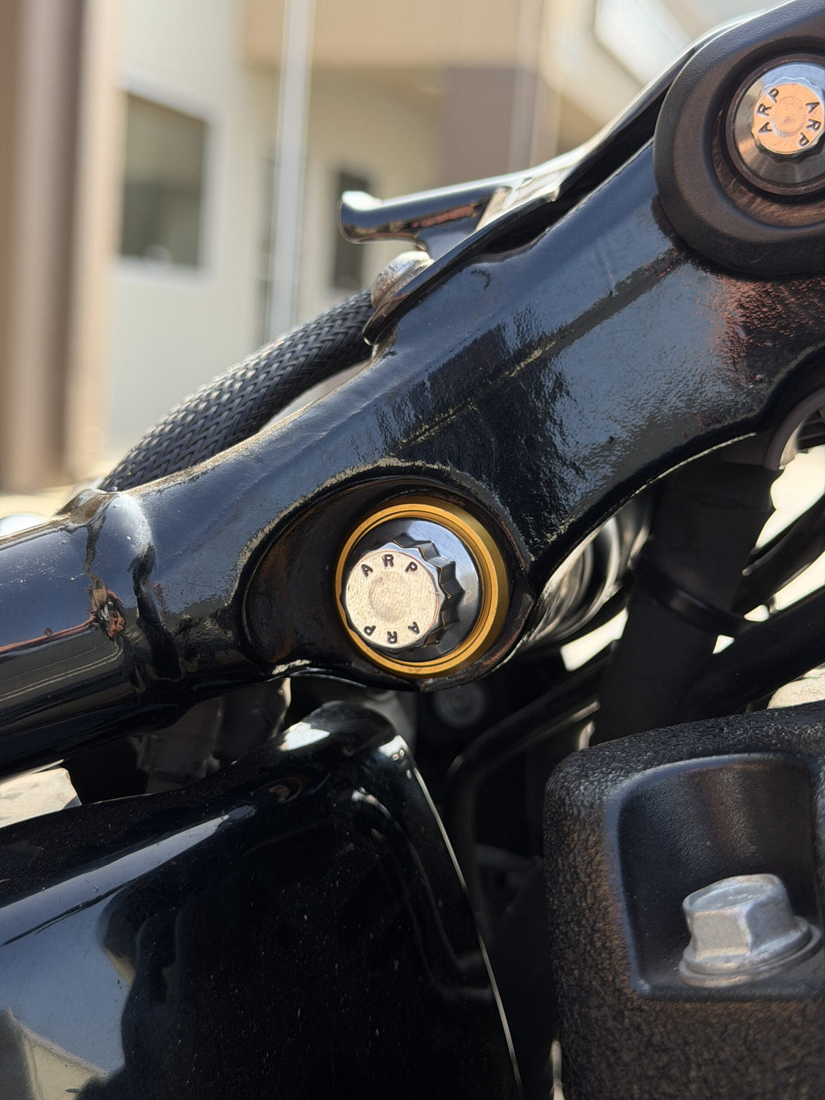 Stainless Steel ARP upper shock mounting bolt for Harley M8 Softail with gold washer