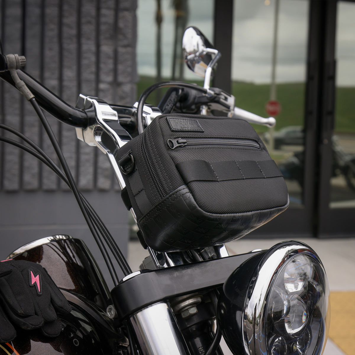 Thrashin Supply crossbody handlebar bag mounted on Harley risers